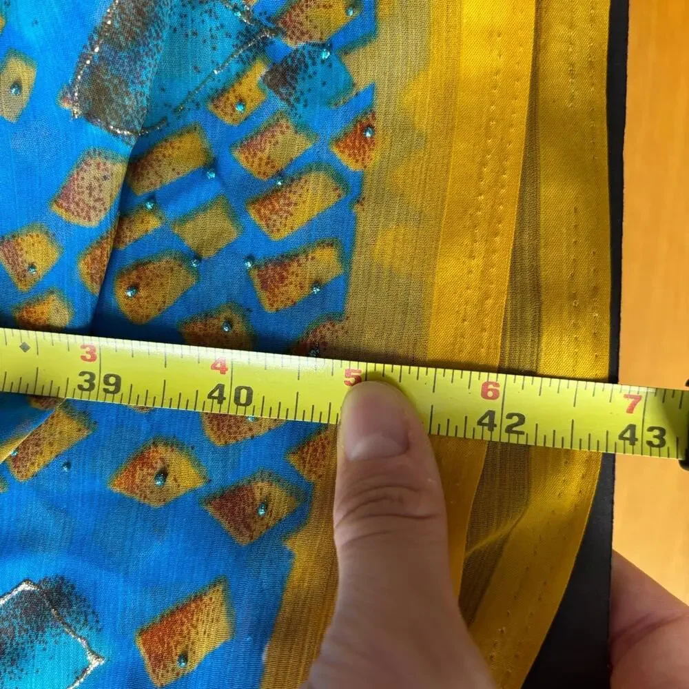 Blue & yellow silk scarf with glitter, gold & white geometric shapes.